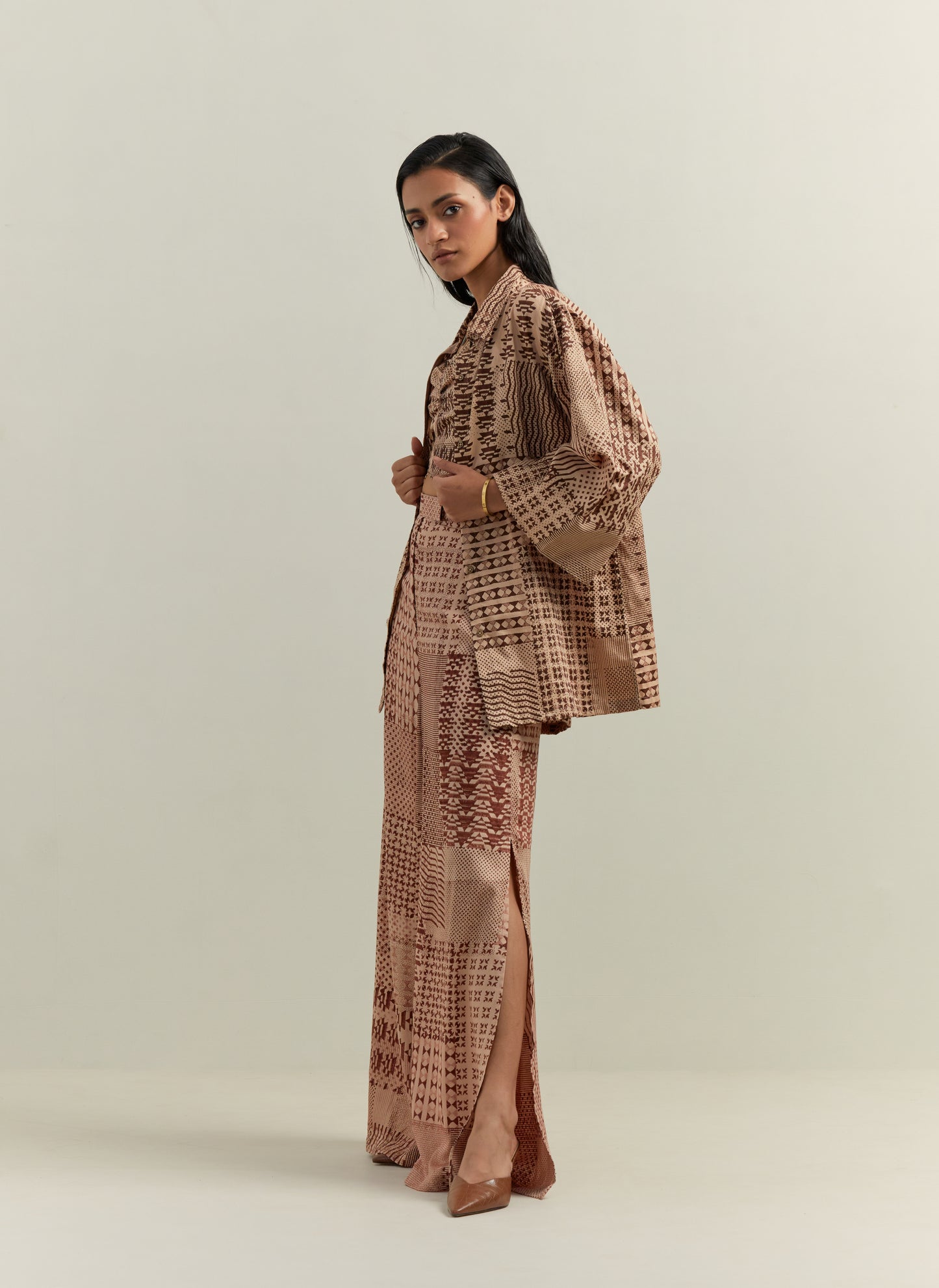 Woman wearing beige block printed co ord set in cotton satin
