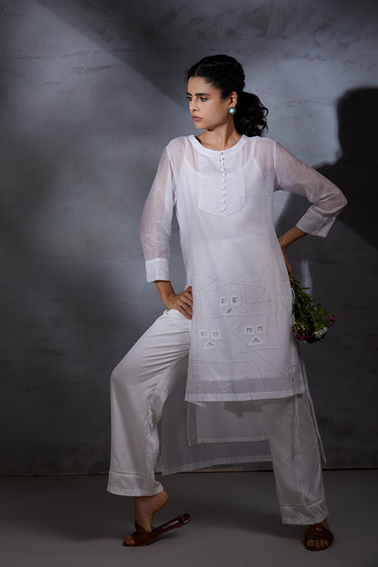 woman wearing white three piece handcrafted party co ord set in silk chanderi