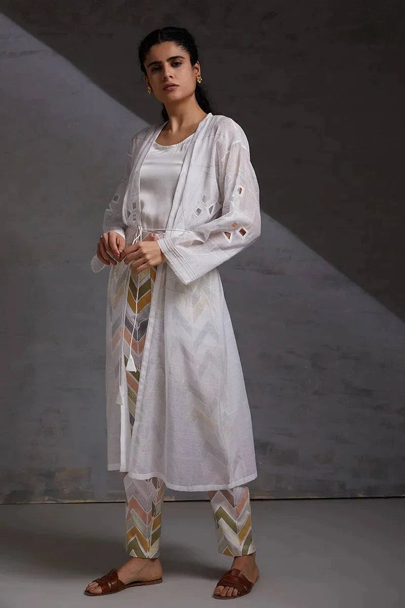 woman wearing white handcrafted co ord set silk chanderi formal wear.