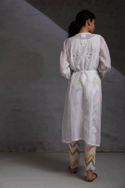 woman wearing white handcrafted co ord set silk chanderi formal wear.